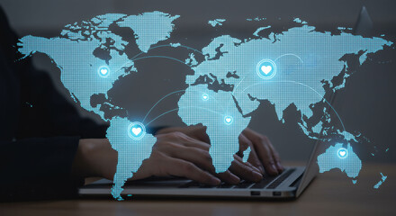 Woman with hands typing on laptop in front of a network world map showing global connection and social media.