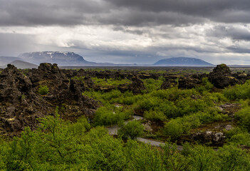 Unique volcanic rock formations and hollow pillars at Dimmuborgir near Lake Myvatn, showcasing the...