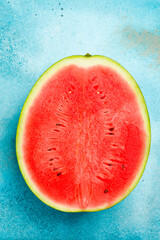 Half of juicy ripe watermelon on a blue stone background. close-up. Free space for text, top view.
