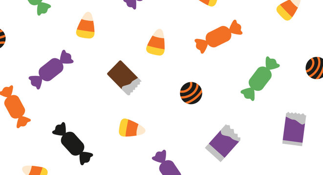 A pattern of assorted Halloween candies including candy corn and chocolate.