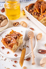 Tasty autumn Cinnamon Pecan Pancake Breakfast baked Casserole with honey. Fall seasonal recipe,  brunch snack for Thanksgiving morning, sweet simple dessert on white table with ingredients for cooking