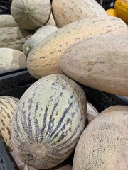big melons on the counter in the store background