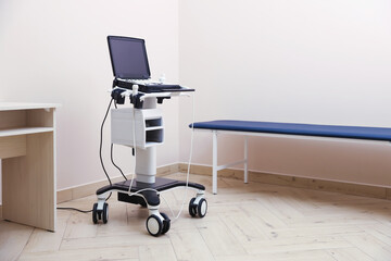 Modern ultrasound machine and examination bed in clinic
