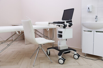 Modern ultrasound machine and examination bed in clinic
