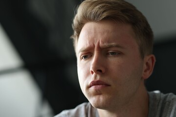 Sad man on blurred background, space for text. Depression