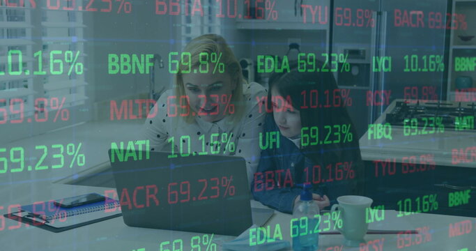 Mother and daughter analyzing stock trends on laptop in home office, with floating overlay and mug