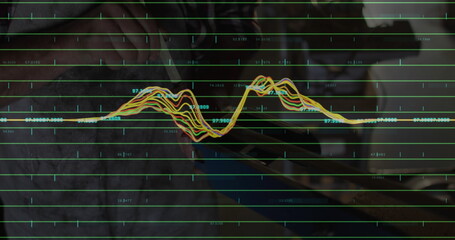 Data analyst analyzing waveform on tablet screen at home office desk, with stylus and laptop