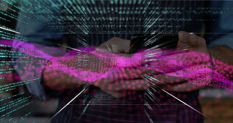 Adult man in striped shirt holding tablet and navigating code streams at office, with magenta waves