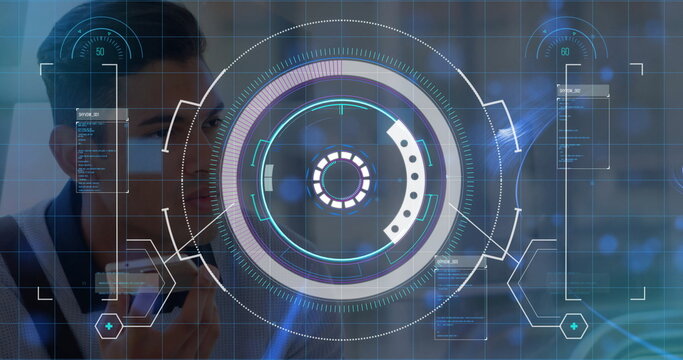 Developer holding smartphone up to face in high tech lab, with HUD and data panels