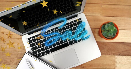 Displaying neon-blue Sale overlay, silver laptop sitting on wooden office desk, with star confetti