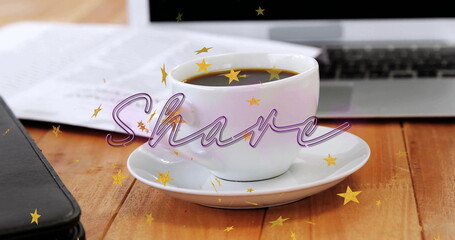 Showing white ceramic coffee cup on saucer on wood table with open laptop, planner and documents
