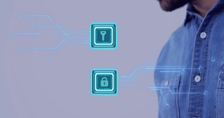 Gazing denim-shirted male examining holographic key and padlock icons on purple wall, copy space