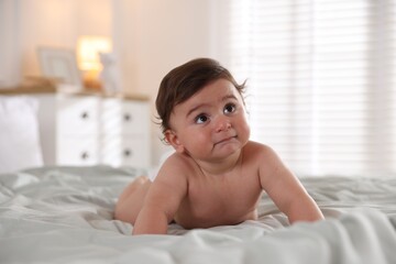 Cute little baby on bed at home