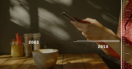 Female hand in red blouse tapping smartphone timeline on cafe table beside ceramic cup, copy space