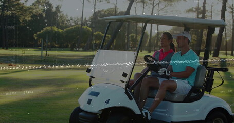 Driving man wearing golf glove steering electric golf cart on fairway, with woman in pink polo