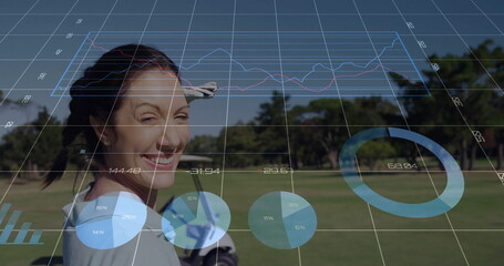 Smiling middle-aged woman holding club on fairway, with golf glove and augmented reality analytics