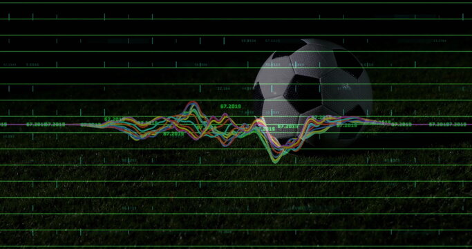 Displaying soccer ball resting on grass field at night, with floating data grid and waveform graph