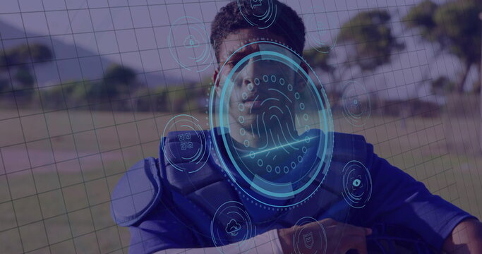 Standing adult male catcher wearing blue chest protector at baseball field, with biometric HUD - Powered by Adobe