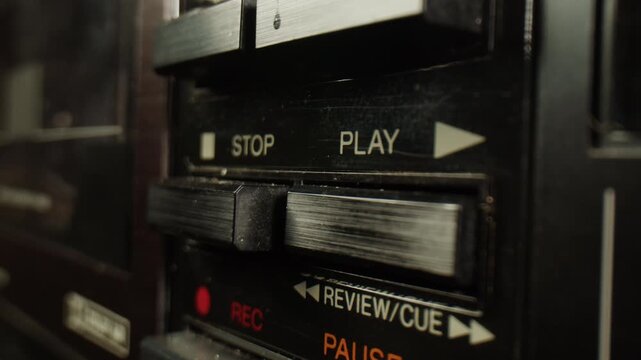 Retro radio tape recorder, audio cassette close-up. Listening to music, old radio boom box player, macro of vintage music listening. 