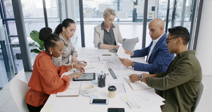 Finance, team and business people in office for planning, meeting or financial analysis with graphs. Group, paper and discussion for investment strategy, risk management and budget report with tech - Powered by Adobe