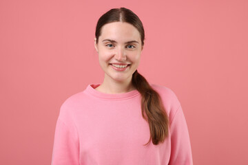Fototapeta premium Beautiful woman laughing on pink background. Positive emotion