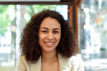 Portrait of smiling Latin American woman in cafe