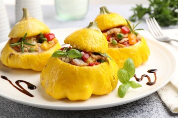 Tasty stuffed pattypan squashes on grey table, closeup