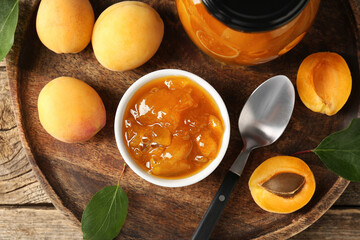 Tasty apricot jam and fresh fruits on wooden table, flat lay