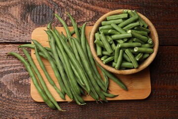 Fresh whole and cut pea pods on wooden table, top view