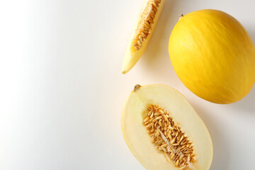 Whole and cut ripe melons on white background, flat lay. Space for text