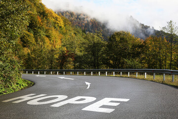 Obraz premium Hope. Word and arrows on asphalt road in mountains