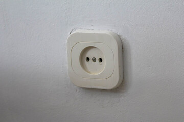 Modern white electrical outlet mounted on clean interior wall in residential home setting