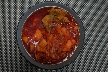 Ukrainian red borscht with meat in a plate. Top view