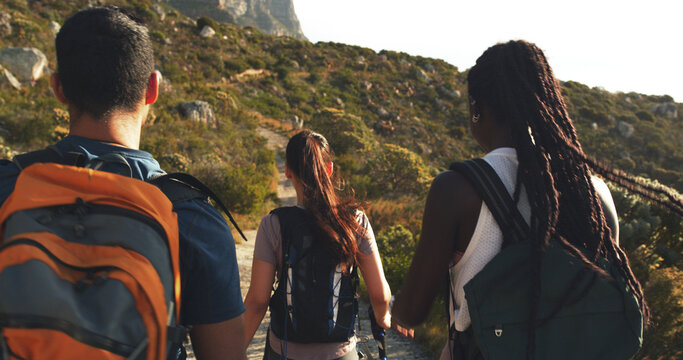 Back, people and friends hiking on mountain for fitness, trekking journey and explore nature. Women, man and travel for backpacking adventure, holiday discovery and wellness activity of getaway trip