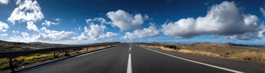 Scenic highway stretching into the distance under a vast sky