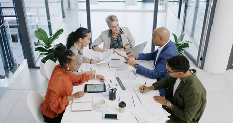 Meeting, group and business people with paperwork for planning, financial analysis and chart above. Team, office and discussion in boardroom for investment, risk management or budget report with tech