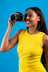 Young photographer smiling and taking photos with analog camera
