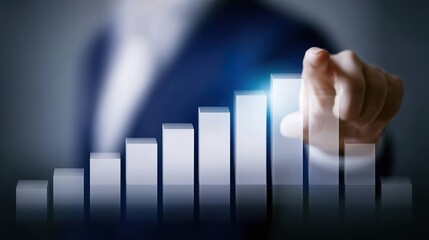 Hand pointing to rising bar graph showing business growth