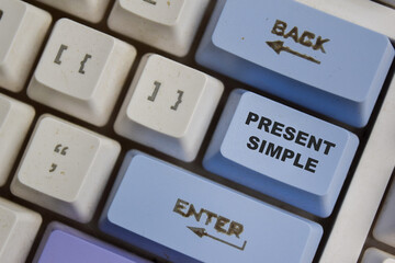 Present Simple one of the verb in modern english on the button keyboard