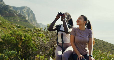Smile, women and friends with binocular for hiking, nature sightseeing and mountain view. Happy,...