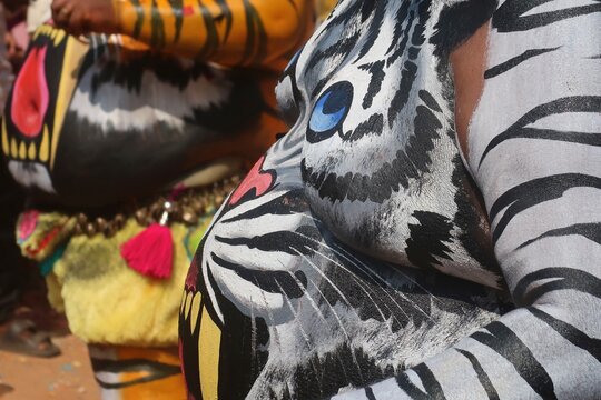 pulikkali is the art performing the special trained artist dancing in the guise of tigers or cheetahs in onam,at thrissur kerala, india