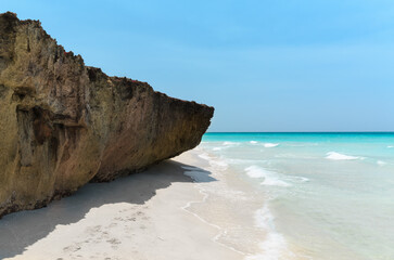 Varadero,Cuba, gorgeous inviting view on white sand majestic beach with old, naturally formatted volcanic cliff, tranquil,turquoise ocean,sunny nice day