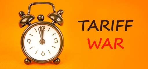 Trade tariff war symbol. Concept word Tariff war on beautiful orange paper. Beautiful black alarm...