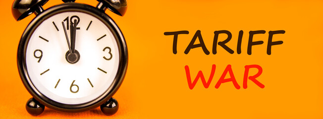 Trade tariff war symbol. Concept word Tariff war on beautiful orange paper. Beautiful black alarm...