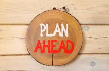 Plan ahead symbol. Concept word Plan ahead on beautiful wooden circle on wooden wall. Beautiful...