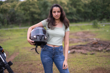 Strong independent Indian woman biker: beautiful girl, stylish rider, motorcycle adventure, elegant...