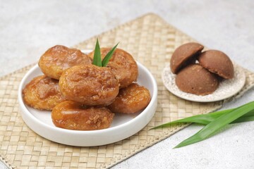 Kue Gemblong. Gemblong is made from white glutinous rice flour dough which is kneaded until smooth and shaped into a slightly flat oval and coated with sugar.