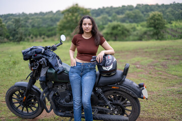 Strong independent Indian woman biker: beautiful girl, stylish rider, motorcycle adventure, elegant...