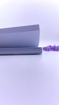 Purple push pins scattered on a white surface. Minimalist flatlay with vibrant contrast. Perfect for productivity visuals, planning themes, or school and office-related designs.