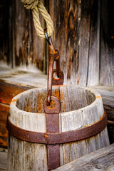 Vintage wooden well with a rope and bucket, displaying rustic charm and craftsmanship in a serene...